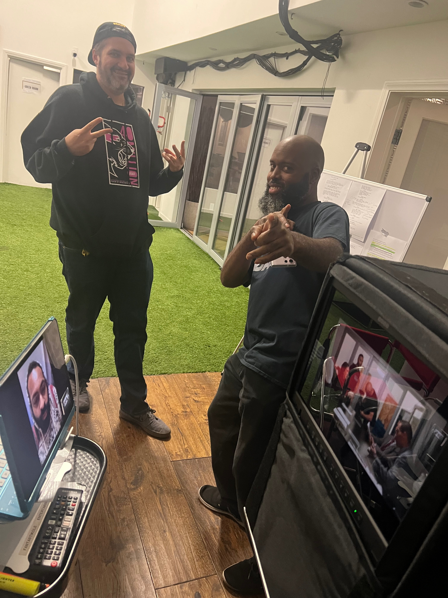Two directors on the Dogbelly set posing near monitors.