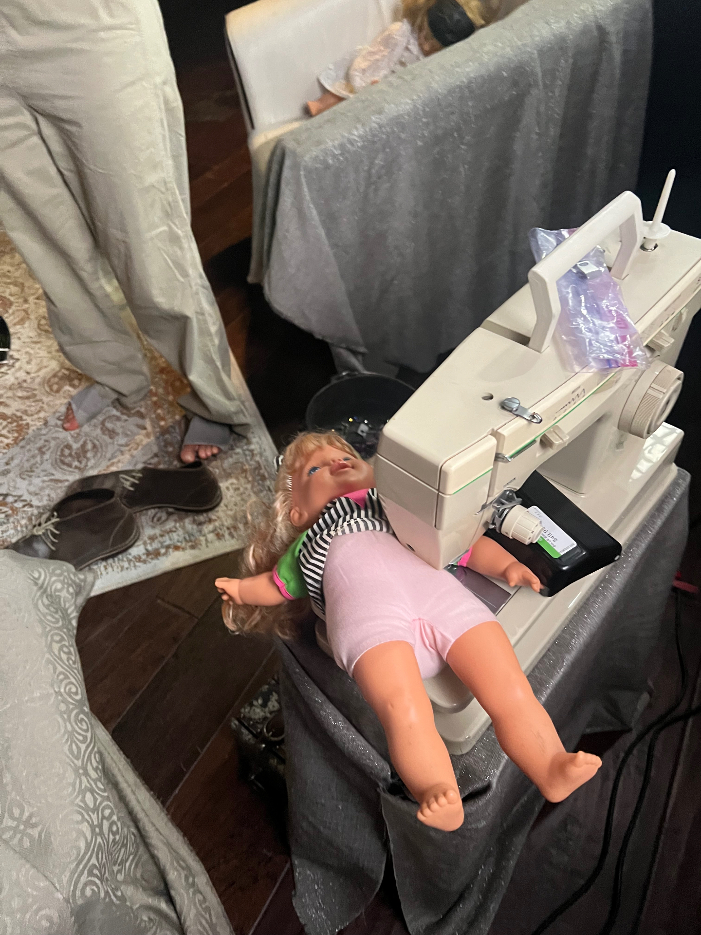 An all star doll displayed beside a sewing machine on the Dogbelly set.