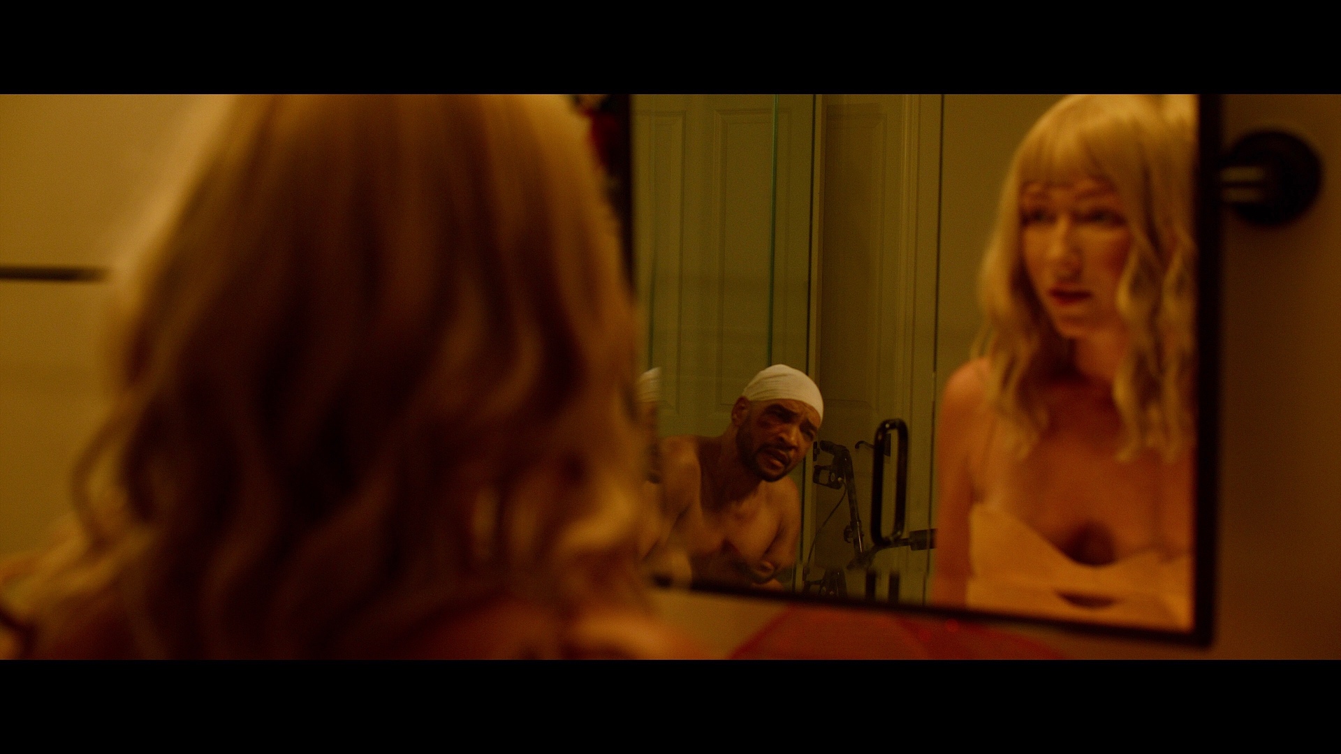 Dogbelly film still: bathroom mirror with two reflections.